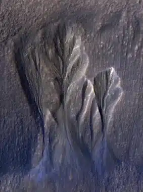 The White Edges Along These Gullies In Mars’ Terra Sirenum Are Believed To Be Dusty Water Ice. Scientists think meltwater could form beneath the surface of this kind of ice, providing a place for possible photosynthesis. This is an enhanced-color image; the blue color would not actually be perceptible to the human eye.
NASA/JPL-Caltech/University of Arizona